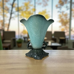 Vintage Hull Pottery vase with scalloped rim, aqua and speckled green glaze, double handles, and flared silhouette, photographed to highlight its mid-century design and glossy ceramic finish.