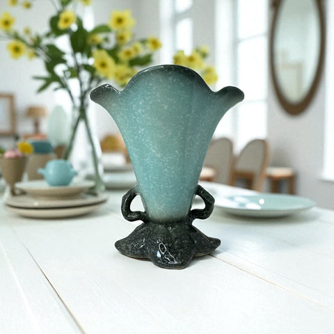 Vintage Hull Pottery vase with scalloped rim, aqua and speckled green glaze, double handles, and flared silhouette, photographed to highlight its mid-century design and glossy ceramic finish.