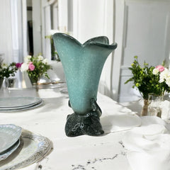 Vintage Hull Pottery vase with scalloped rim, aqua and speckled green glaze, double handles, and flared silhouette, photographed to highlight its mid-century design and glossy ceramic finish.