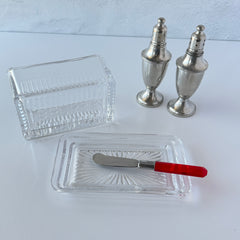 Vintage clear glass butter dish with raised “Beurre” lettering visible through the lid and ribbed radiating base.