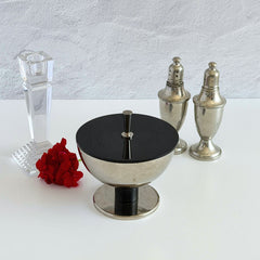 Vintage signed Igi nickel‑plated brass and black plastic modernist candy dish with lid, shown from multiple angles including signature underside.