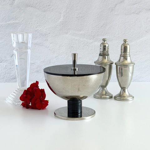 Vintage signed Igi nickel‑plated brass and black plastic modernist candy dish with lid, shown from multiple angles including signature underside.