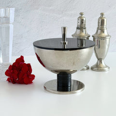 Vintage signed Igi nickel‑plated brass and black plastic modernist candy dish with lid, shown from multiple angles including signature underside.