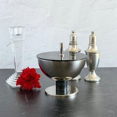 Vintage signed Igi nickel‑plated brass and black plastic modernist candy dish with lid, shown from multiple angles including signature underside.