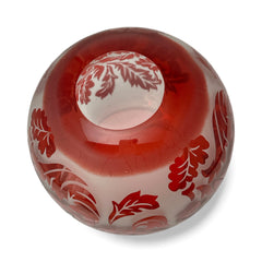 Vintage Illuminations frosted glass candle holder with etched red Spanish lace leaf pattern, rose bowl shape, softly glowing surface ideal for holiday decor or cozy ambiance.