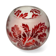 Vintage Illuminations frosted glass candle holder with etched red Spanish lace leaf pattern, rose bowl shape, softly glowing surface ideal for holiday decor or cozy ambiance.