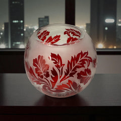 Vintage Illuminations frosted glass candle holder with etched red Spanish lace leaf pattern, rose bowl shape, softly glowing surface ideal for holiday decor or cozy ambiance.