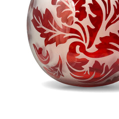 Vintage Illuminations frosted glass candle holder with etched red Spanish lace leaf pattern, rose bowl shape, softly glowing surface ideal for holiday decor or cozy ambiance.