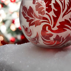 Vintage Illuminations frosted glass candle holder with etched red Spanish lace leaf pattern, rose bowl shape, softly glowing surface ideal for holiday decor or cozy ambiance.