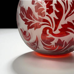 Vintage Illuminations frosted glass candle holder with etched red Spanish lace leaf pattern, rose bowl shape, softly glowing surface ideal for holiday decor or cozy ambiance.