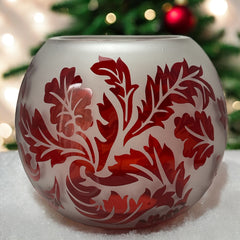 Vintage Illuminations frosted glass candle holder with etched red Spanish lace leaf pattern, rose bowl shape, softly glowing surface ideal for holiday decor or cozy ambiance.