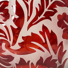 Vintage Illuminations frosted glass candle holder with etched red Spanish lace leaf pattern, rose bowl shape, softly glowing surface ideal for holiday decor or cozy ambiance.