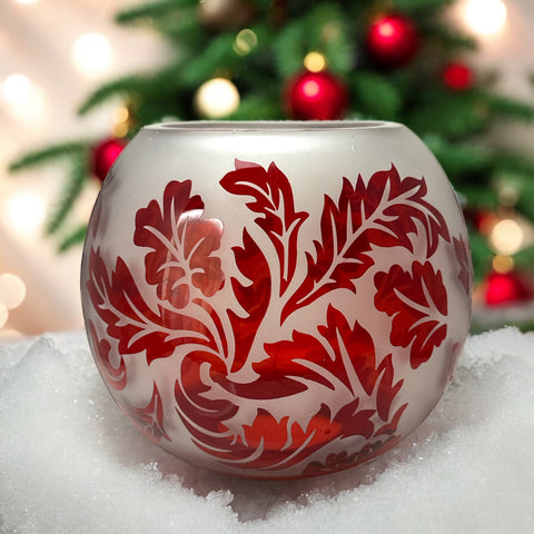 Vintage Illuminations frosted glass candle holder with etched red Spanish lace leaf pattern, rose bowl shape, softly glowing surface ideal for holiday decor or cozy ambiance.