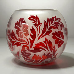 Vintage Illuminations frosted glass candle holder with etched red Spanish lace leaf pattern, rose bowl shape, softly glowing surface ideal for holiday decor or cozy ambiance.