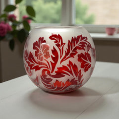 Vintage Illuminations frosted glass candle holder with etched red Spanish lace leaf pattern, rose bowl shape, softly glowing surface ideal for holiday decor or cozy ambiance.