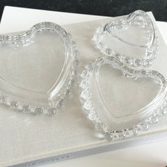 Vintage Imperial clear glass Candlewick heart-shaped dishes in a set of three, shown in various arrangements for decorative or serving use.