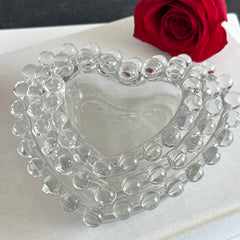 Vintage Imperial clear glass Candlewick heart-shaped dishes in a set of three, shown in various arrangements for decorative or serving use.