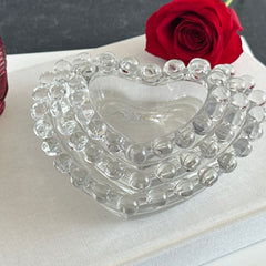 Vintage Imperial clear glass Candlewick heart-shaped dishes in a set of three, shown in various arrangements for decorative or serving use.