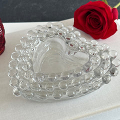 Vintage Imperial clear glass Candlewick heart-shaped dishes in a set of three, shown in various arrangements for decorative or serving use.