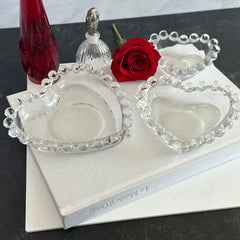 Vintage Imperial clear glass Candlewick heart-shaped dishes in a set of three, shown in various arrangements for decorative or serving use.