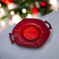 Vintage Imperial Glass Ruby Red Molly serving dish with hexagonal shape, twin handles, and low footed base, shown in various lighting to highlight its translucent red pressed glass and geometric design.