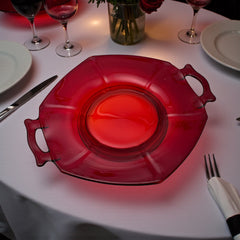 Vintage Imperial Glass Ruby Red Molly serving dish with hexagonal shape, twin handles, and low footed base, shown in various lighting to highlight its translucent red pressed glass and geometric design.