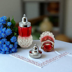 Pair of vintage Indiana Glass salt and pepper shakers featuring clear diamond point bases, paneled ruby red flash bands, and chrome-plated screw-on lids marked Made in Hong Kong. Mid-century design in excellent vintage condition.