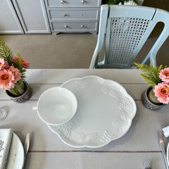  Vintage Indiana Glass Colony Harvest Grape milk glass snack plate and cup set from the 1960s, featuring embossed grapevine motifs and glossy white finish.
