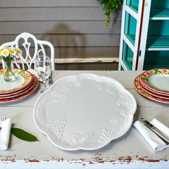  Vintage Indiana Glass Colony Harvest Grape milk glass snack plate and cup set from the 1960s, featuring embossed grapevine motifs and glossy white finish.
