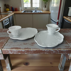  Vintage Indiana Glass Colony Harvest Grape milk glass snack plate and cup set from the 1960s, featuring embossed grapevine motifs and glossy white finish.
