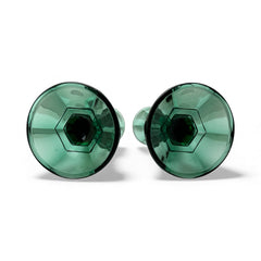 Pair of vintage Indiana Glass green candlestick holders with hexagonal bases, shown on a white surface. The emerald green glass catches the light, highlighting their faceted mid-century design and tapered silhouette. Ideal for holiday styling or eco-conscious vintage decor.