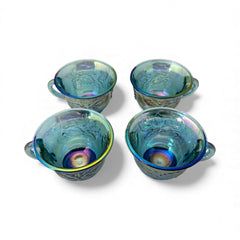 Set of four vintage Indiana Glass punch or tea cups in Princess Blue Harvest Grape pattern, made in the early 1970s; iridescent blue glass with embossed grape and leaf motifs, each cup approx. 2⅜" tall and 3⅜" in diameter, with 4¼" width including handle; excellent vintage condition with vibrant multicolor sheen.