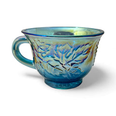 Set of four vintage Indiana Glass punch or tea cups in Princess Blue Harvest Grape pattern, made in the early 1970s; iridescent blue glass with embossed grape and leaf motifs, each cup approx. 2⅜" tall and 3⅜" in diameter, with 4¼" width including handle; excellent vintage condition with vibrant multicolor sheen.