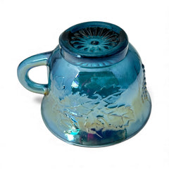 Set of four vintage Indiana Glass punch or tea cups in Princess Blue Harvest Grape pattern, made in the early 1970s; iridescent blue glass with embossed grape and leaf motifs, each cup approx. 2⅜" tall and 3⅜" in diameter, with 4¼" width including handle; excellent vintage condition with vibrant multicolor sheen.