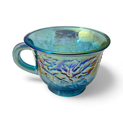 Set of four vintage Indiana Glass punch or tea cups in Princess Blue Harvest Grape pattern, made in the early 1970s; iridescent blue glass with embossed grape and leaf motifs, each cup approx. 2⅜" tall and 3⅜" in diameter, with 4¼" width including handle; excellent vintage condition with vibrant multicolor sheen.