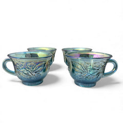 Set of four vintage Indiana Glass punch or tea cups in Princess Blue Harvest Grape pattern, made in the early 1970s; iridescent blue glass with embossed grape and leaf motifs, each cup approx. 2⅜" tall and 3⅜" in diameter, with 4¼" width including handle; excellent vintage condition with vibrant multicolor sheen.