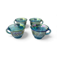 Set of four vintage Indiana Glass punch or tea cups in Princess Blue Harvest Grape pattern, made in the early 1970s; iridescent blue glass with embossed grape and leaf motifs, each cup approx. 2⅜" tall and 3⅜" in diameter, with 4¼" width including handle; excellent vintage condition with vibrant multicolor sheen.