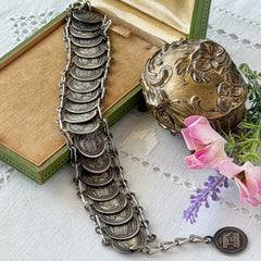 Vintage Italian Rome souvenir coin bracelet with silver‑tone medals of Colosseum, San Pietro, and she‑wolf, adjustable length.