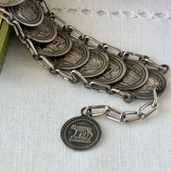 Vintage Italian Rome souvenir coin bracelet with silver‑tone medals of Colosseum, San Pietro, and she‑wolf, adjustable length.