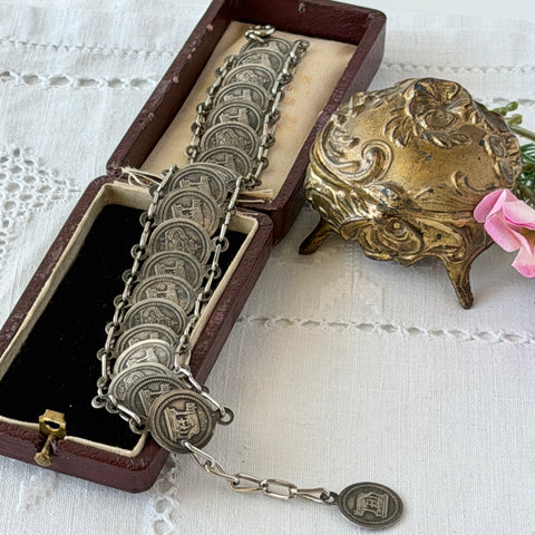 Vintage Italian Rome souvenir coin bracelet with silver‑tone medals of Colosseum, San Pietro, and she‑wolf, adjustable length.