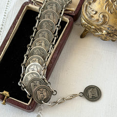 Vintage Italian Rome souvenir coin bracelet with silver‑tone medals of Colosseum, San Pietro, and she‑wolf, adjustable length.