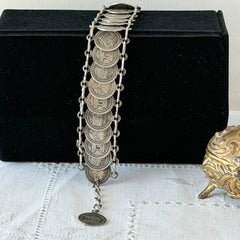 Vintage Italian Rome souvenir coin bracelet with silver‑tone medals of Colosseum, San Pietro, and she‑wolf, adjustable length.