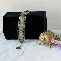 Vintage Italian Rome souvenir coin bracelet with silver‑tone medals of Colosseum, San Pietro, and she‑wolf, adjustable length.