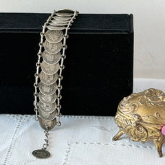 Vintage Italian Rome souvenir coin bracelet with silver‑tone medals of Colosseum, San Pietro, and she‑wolf, adjustable length.