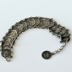 Vintage Italian Rome souvenir coin bracelet with silver‑tone medals of Colosseum, San Pietro, and she‑wolf, adjustable length.