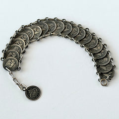 Vintage Italian Rome souvenir coin bracelet with silver‑tone medals of Colosseum, San Pietro, and she‑wolf, adjustable length.