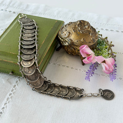 Vintage Italian Rome souvenir coin bracelet with silver‑tone medals of Colosseum, San Pietro, and she‑wolf, adjustable length.