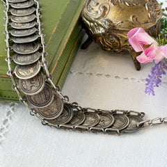 Vintage Italian Rome souvenir coin bracelet with silver‑tone medals of Colosseum, San Pietro, and she‑wolf, adjustable length.
