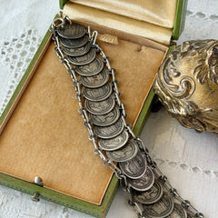 Vintage Italian Rome souvenir coin bracelet with silver‑tone medals of Colosseum, San Pietro, and she‑wolf, adjustable length.