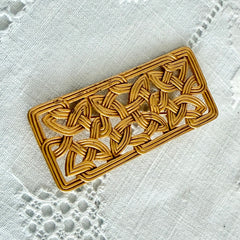 Vintage JJ Jonette brooch with interwoven Celtic knot design in gold‑tone metal, shown from various angles to display details and condition.